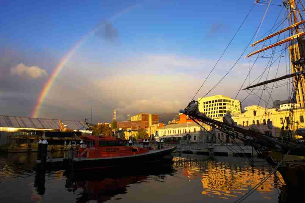 a rainbow at sunrise at the Hobart waterfront