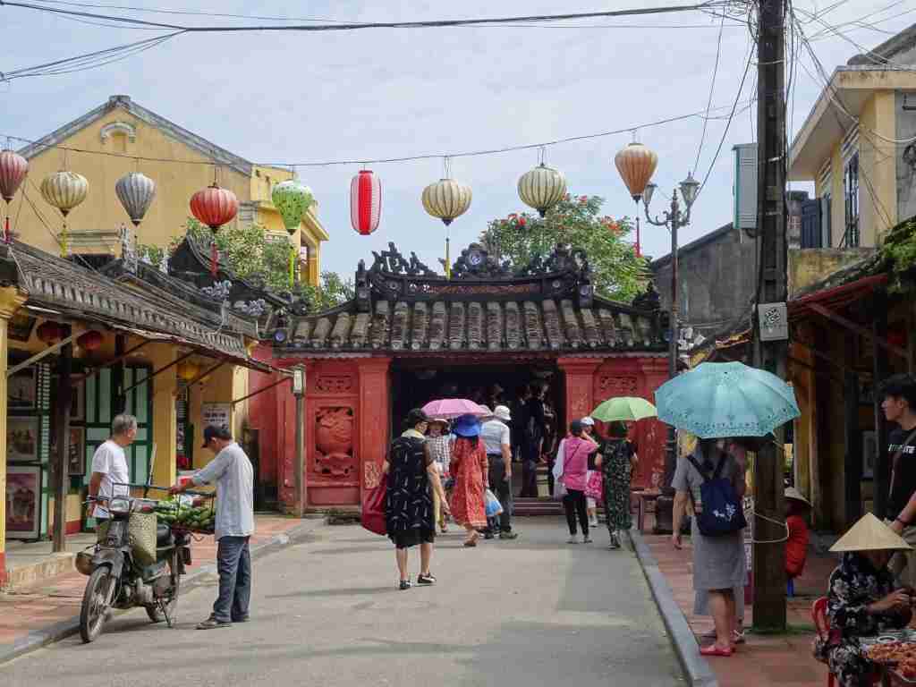 people carrying sun umbrellas on the laneways of Hoi An Vietnam in 2 weeks