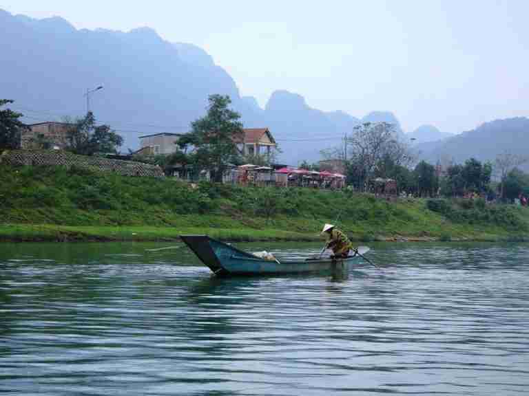 a small blue boat on the Son River, Phong Nha Vietnam