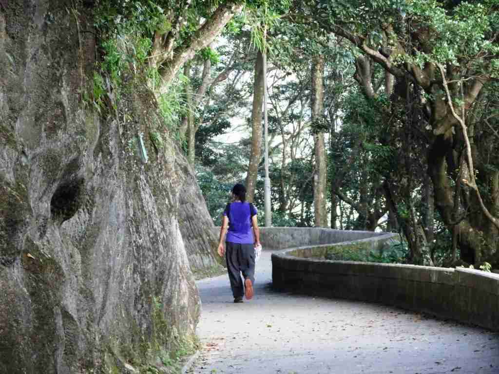 woman walking on a winding path on the peak, one of the top attractions in Hong Kong