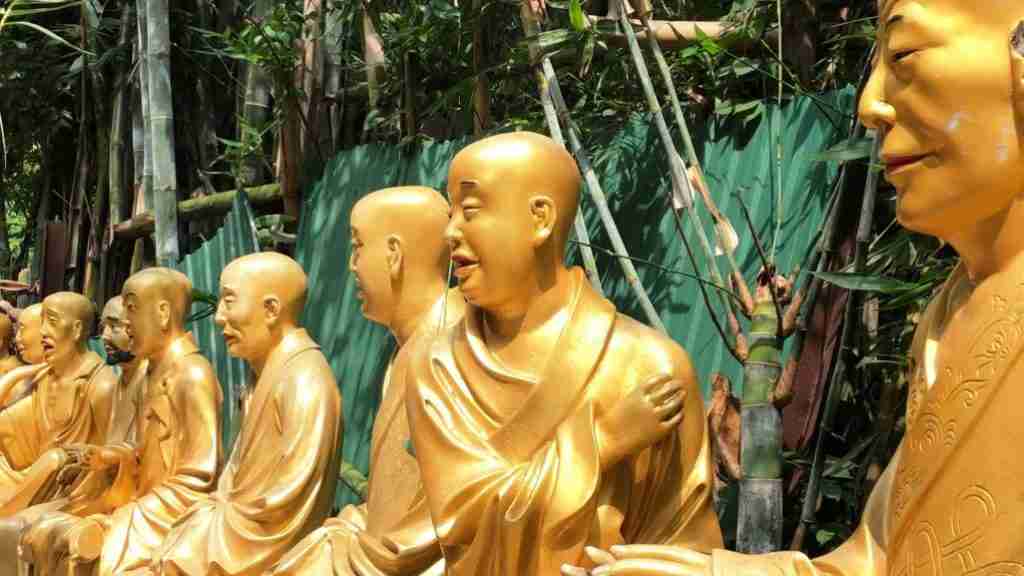 rows of golden Buddhas at The Ten Thousand Buddhas Monastery Hong Kong