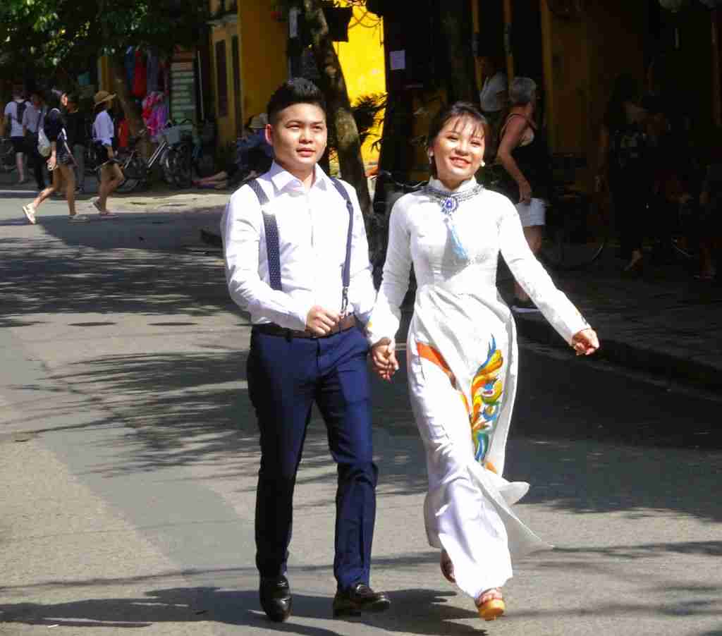 A Vietnamese couple walking down the laneways of Hoi An