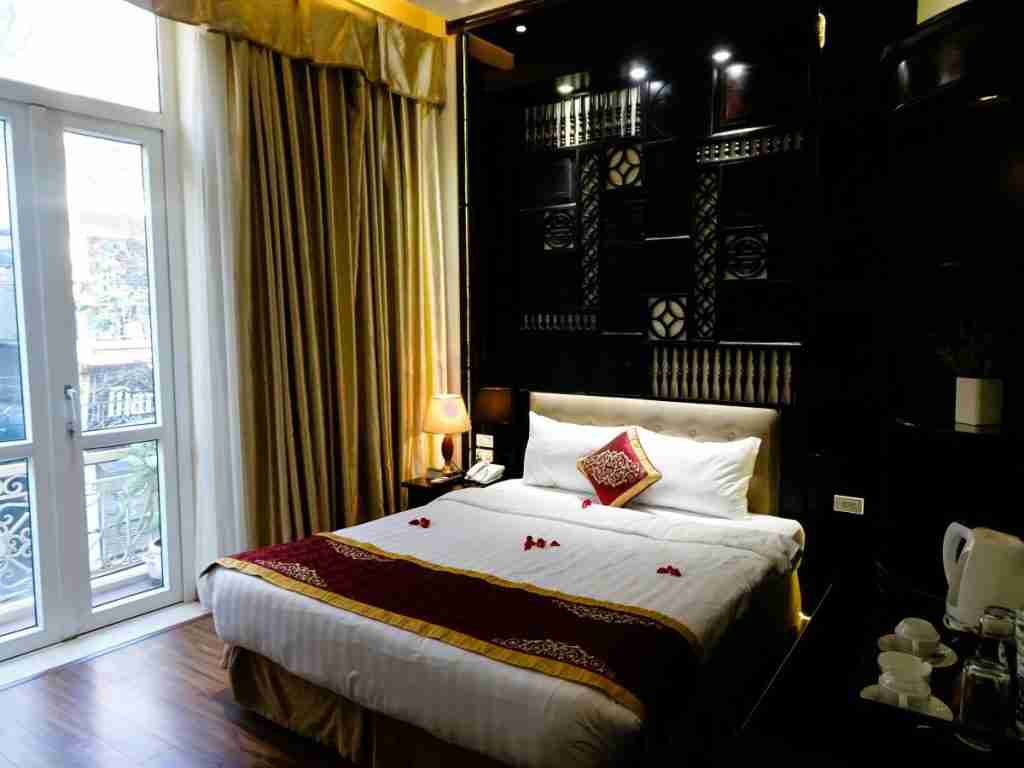 carved wooden bed head at the Hanoi Graceful Hotel