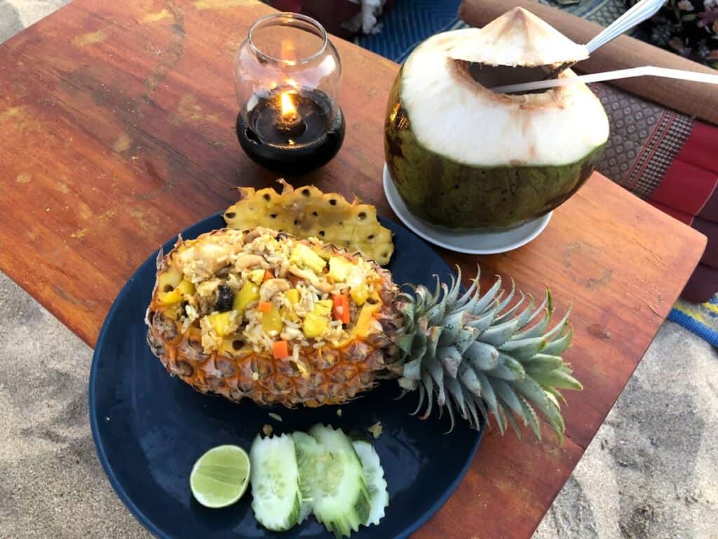 Delicious pineapple fried rice with a coconut and a beach sunset in Koh Lanta solo travelling to Thailand