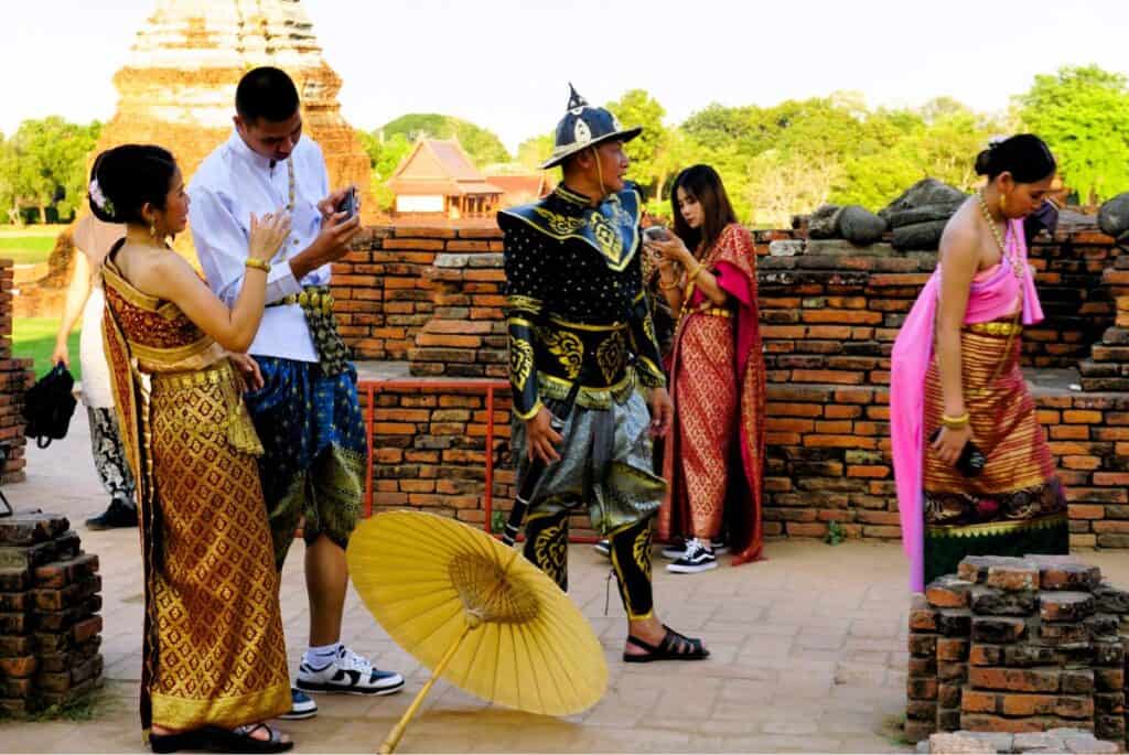 Thai people posing for photos at the temple ruins at Wat Chai Wattanaram in Ayutthaya Thailand