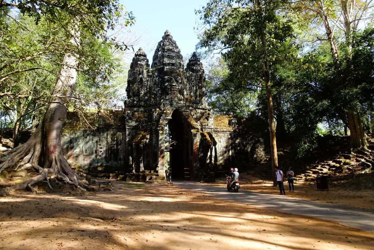 The ancient stone ruins of Angkor Wat surrounded by jungle