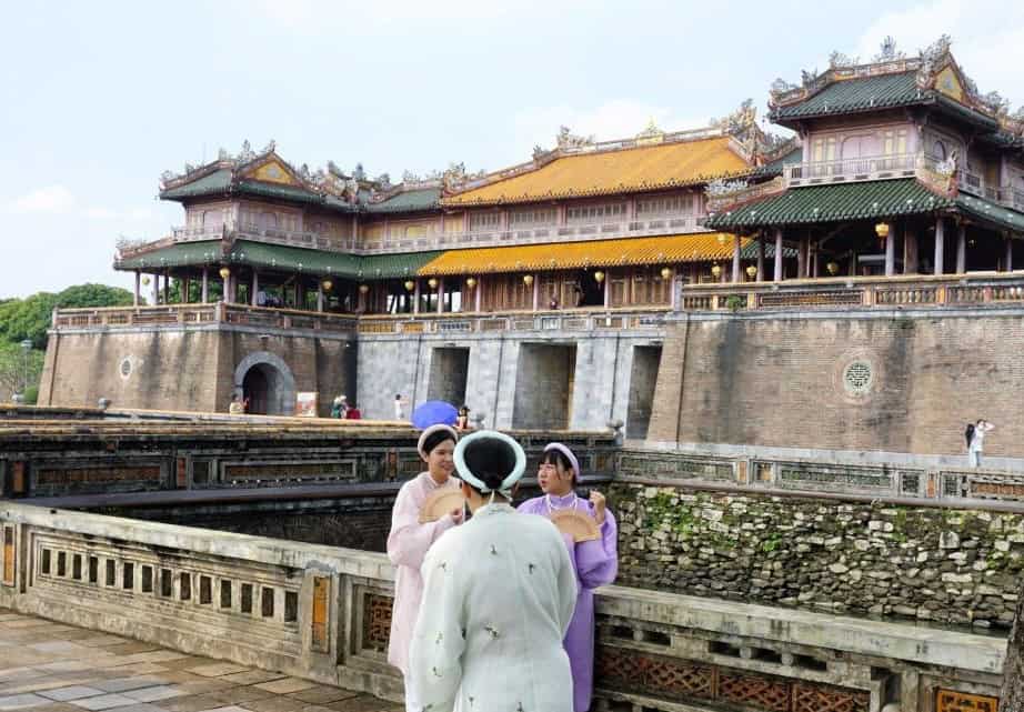 people dressed in traditional clothes outside the Hue Imperial citadel