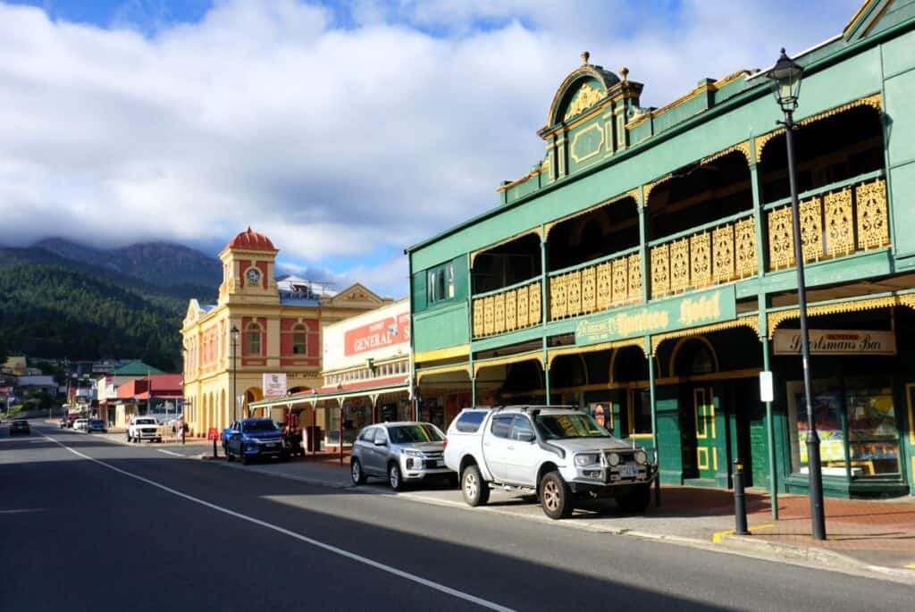 a green restored heritage hotel and yellow post office on Queenstown Tasmania