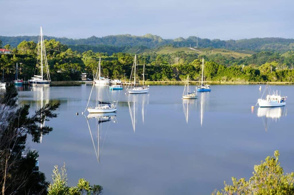 Boats moored in a quiet harbour in Strahan Tasmania