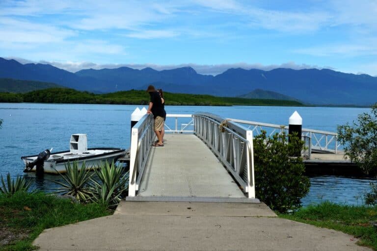 Port Douglas or Cairns? A couple on a jetty enjoying water views
