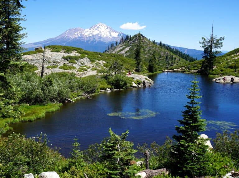 snowcapped Mount Shasta rising behind blue Little Heart lake