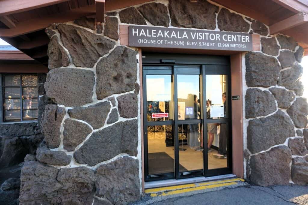 Haleakalā Visitor Center entrance with stone walls and glass doors.