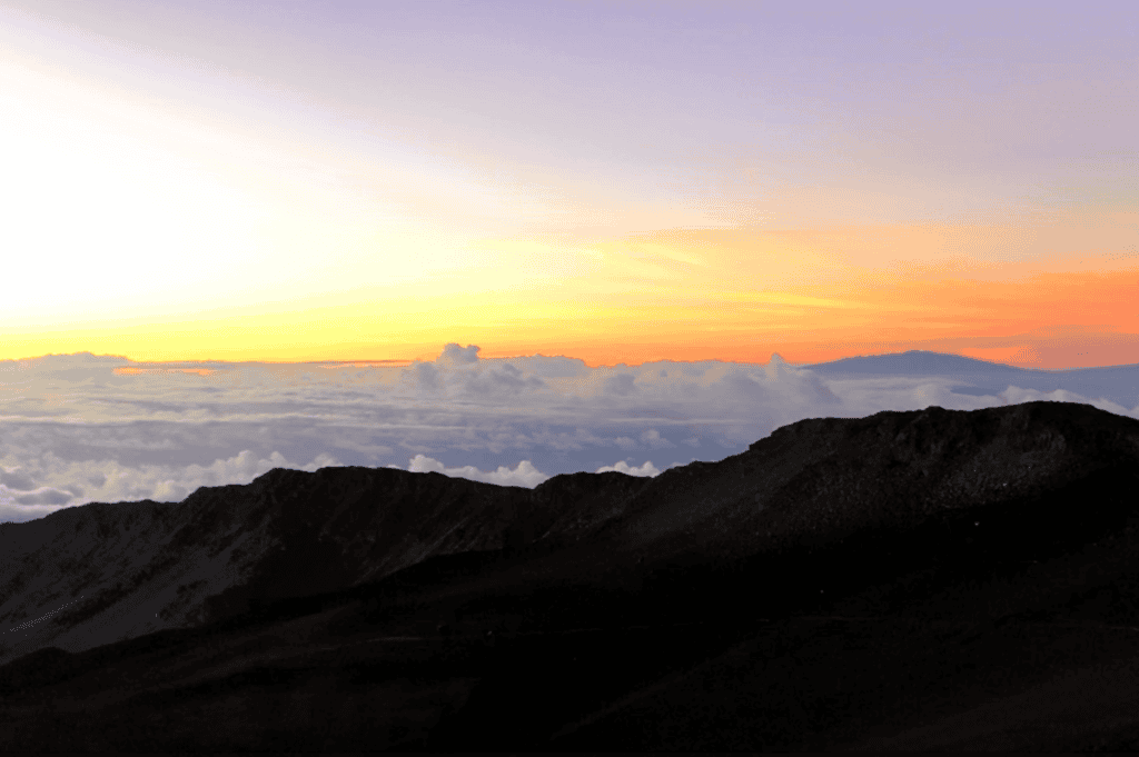 sunrise colurs reflected in the clouds at Haleakala Maui
