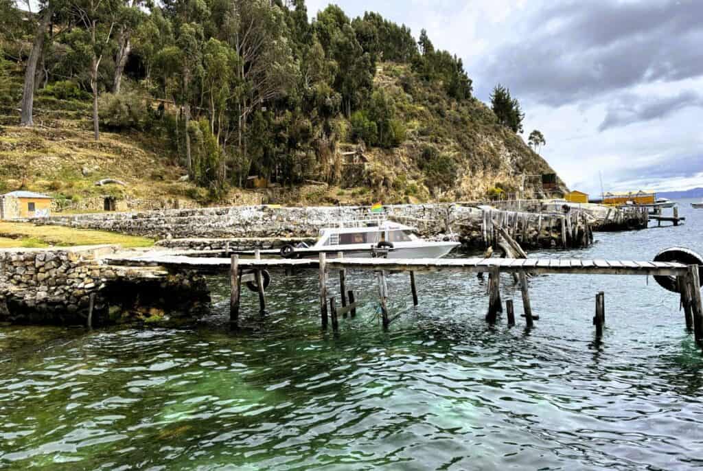 wooden pier over a green blue lake